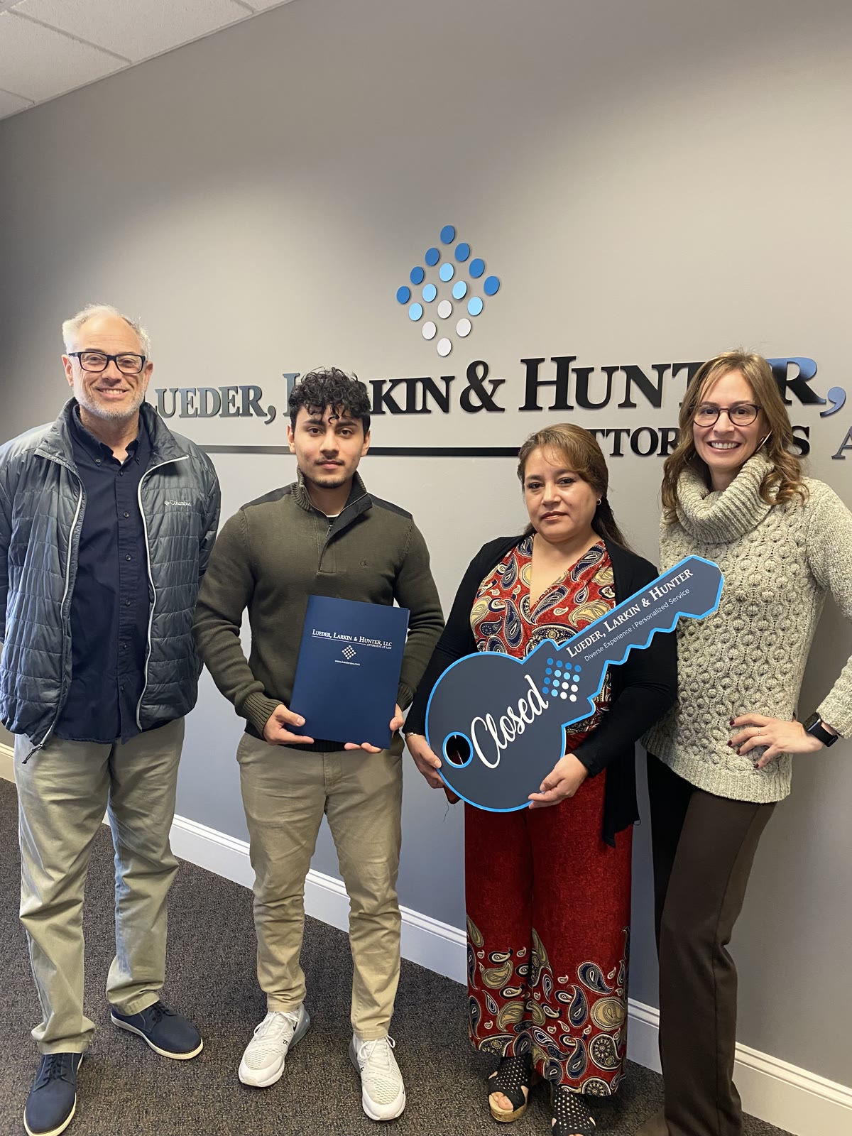 Justin Trevilla with clients and closing attorneys after a completed purchase