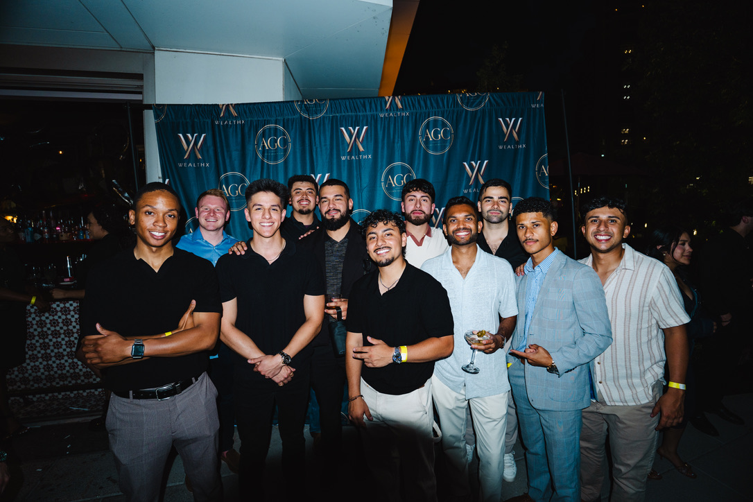 WealthX ATL attendees together in front of the event backdrop