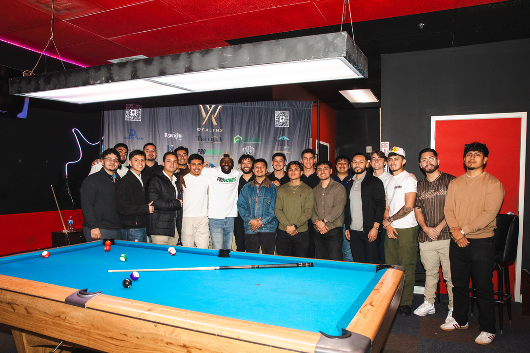 WealthX ATL members gathered around a billiards table